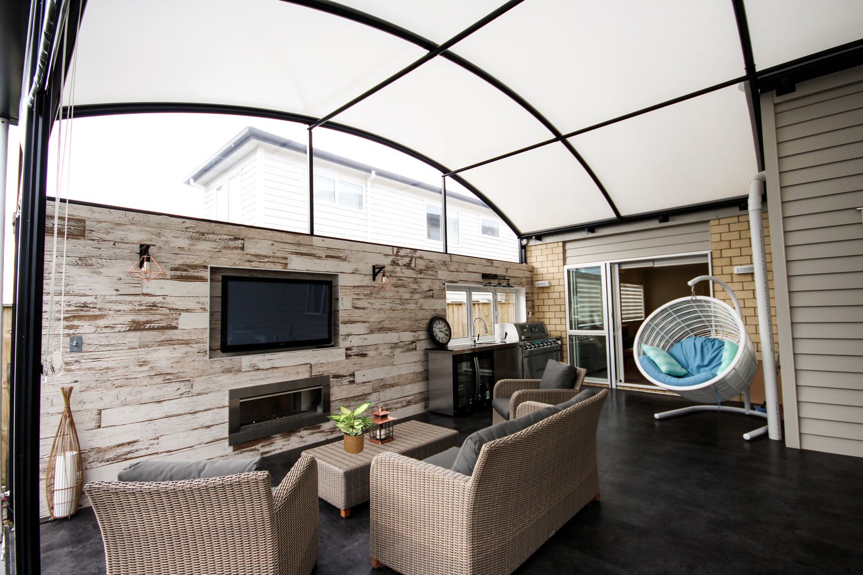 outdoor tv room covered by a fresco awning